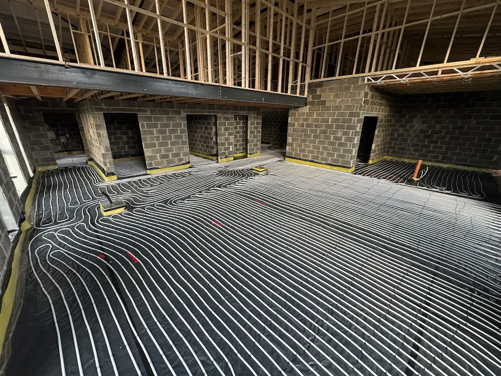 Underfloor heating pipework being installed on a large new-build project by Vector Heat